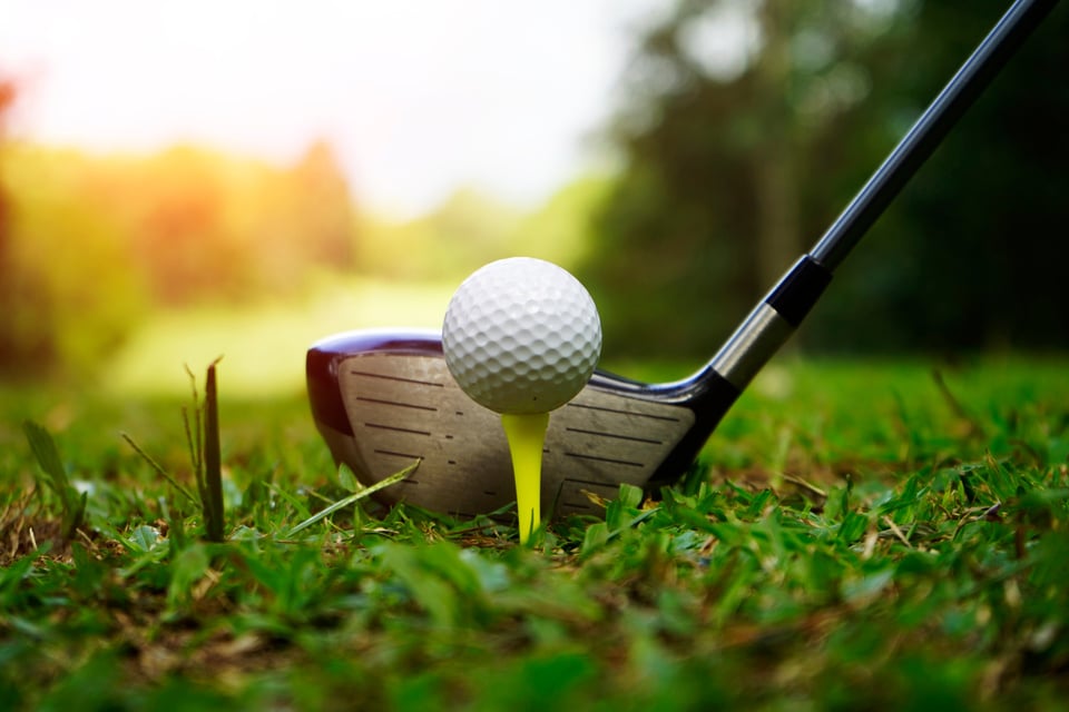 Golf ball and golf club in beautiful golf course at sunset background. Golf ball on green in golf course at Thailand