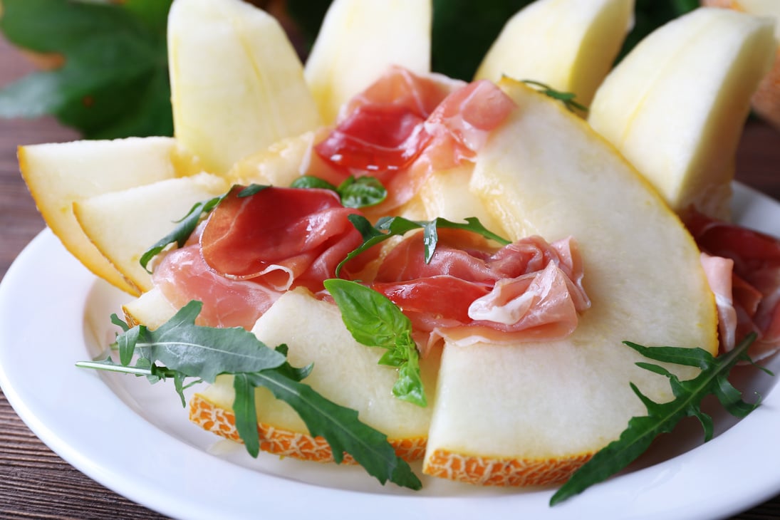 Melon with Prosciutto of Parma Ham on Plate, Close-up